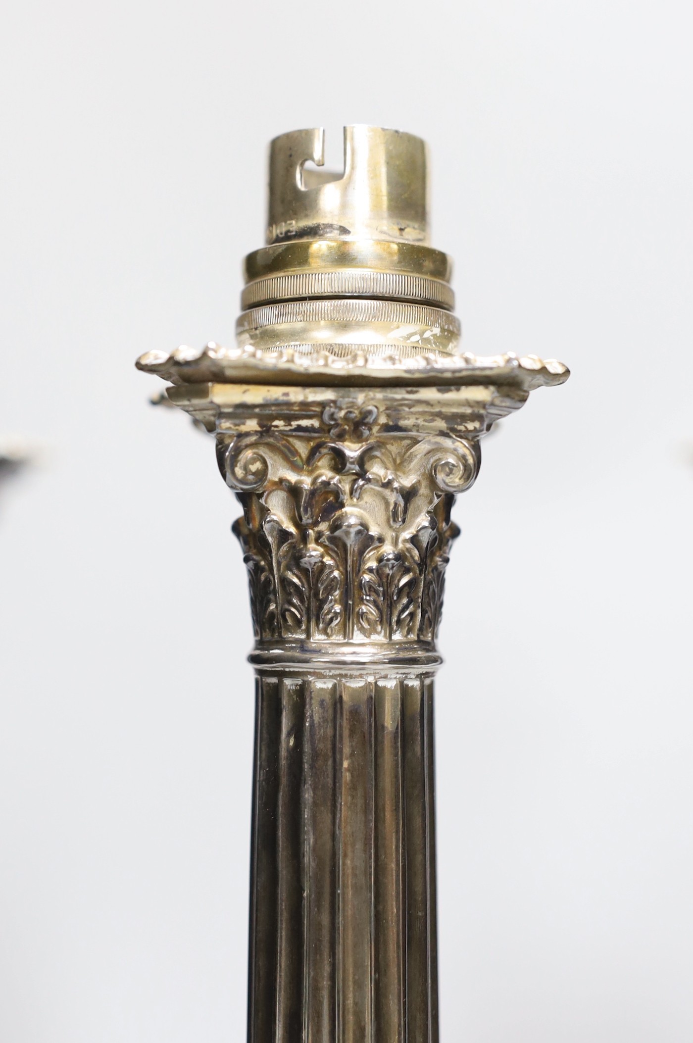 A set of four early 20th century silver plated Corinthian column table lamps on marble stands 33cms high (not including light fitting)